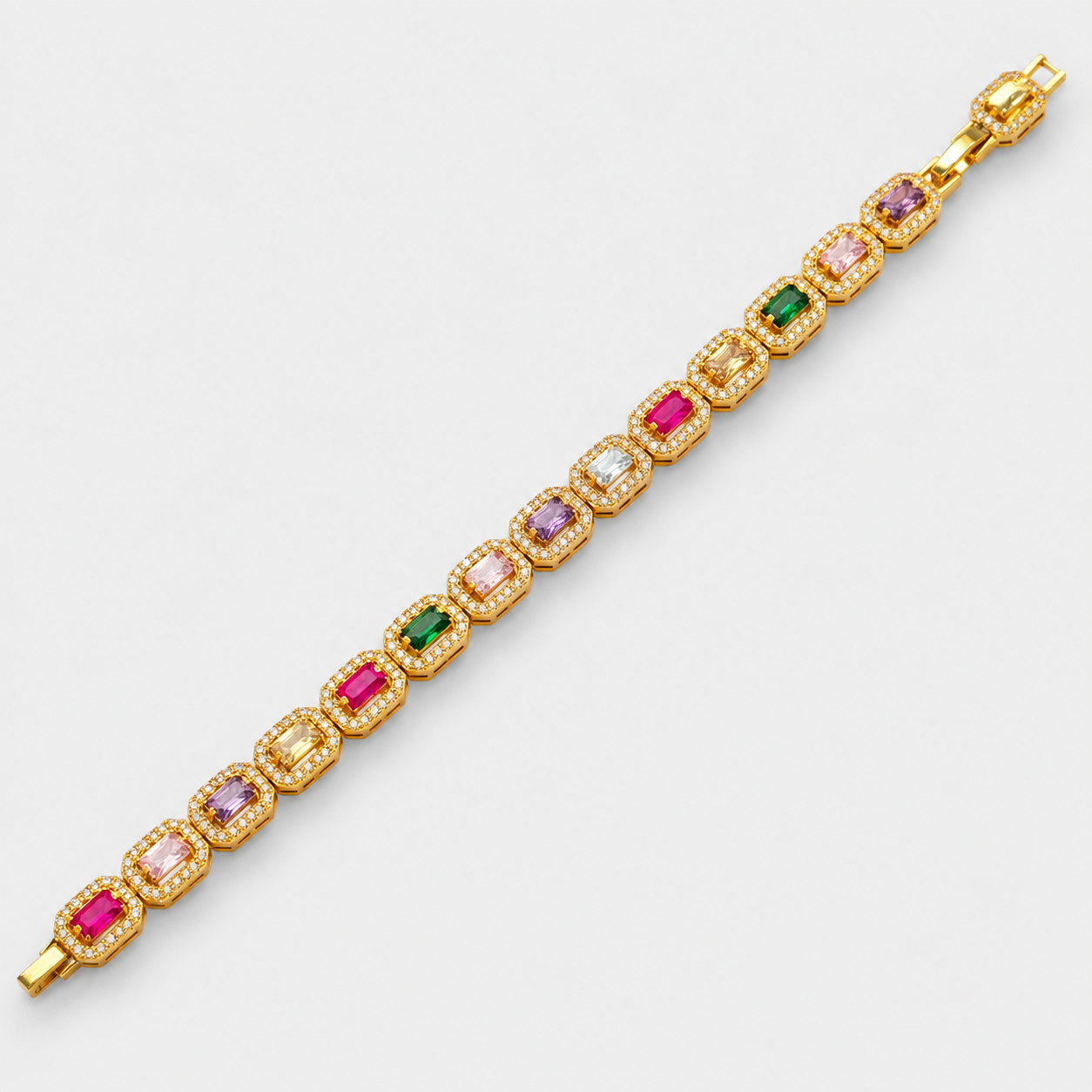 A gold-plated tennis bracelet featuring a row of rectangular emerald-cut gemstones in pink, purple, green, and yellow, each surrounded by small clear stones, displayed diagonally on a light gray background.